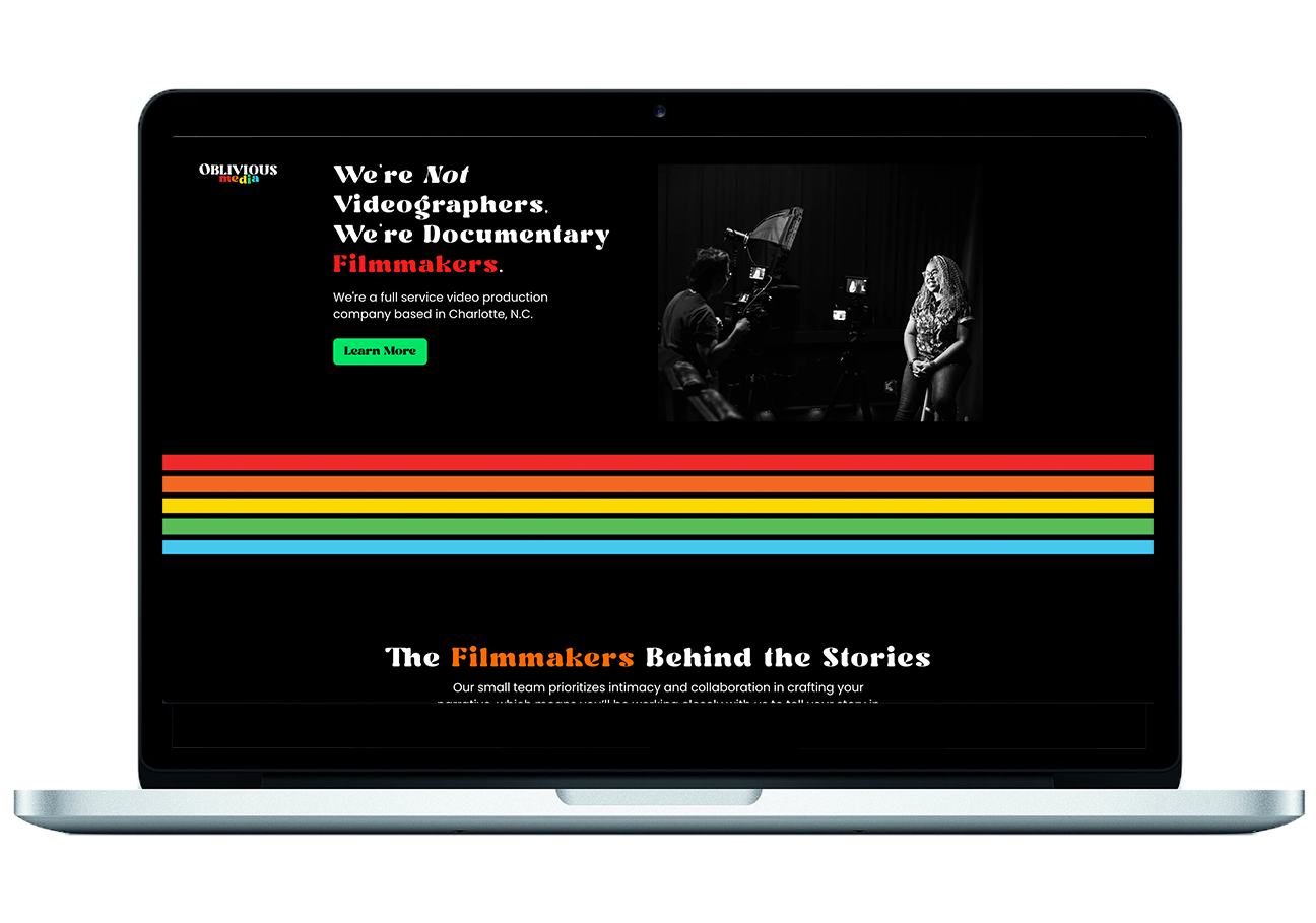 A web design showcased on a laptop. The background is black with a horizontal rainbow page break. Above the break is a black and white photo and web copy that reads, "We're Not Videographers, We're Documentary Filmmakers," as well as, "We're a Full Service Video Production Company Based in Charlotte, NC".